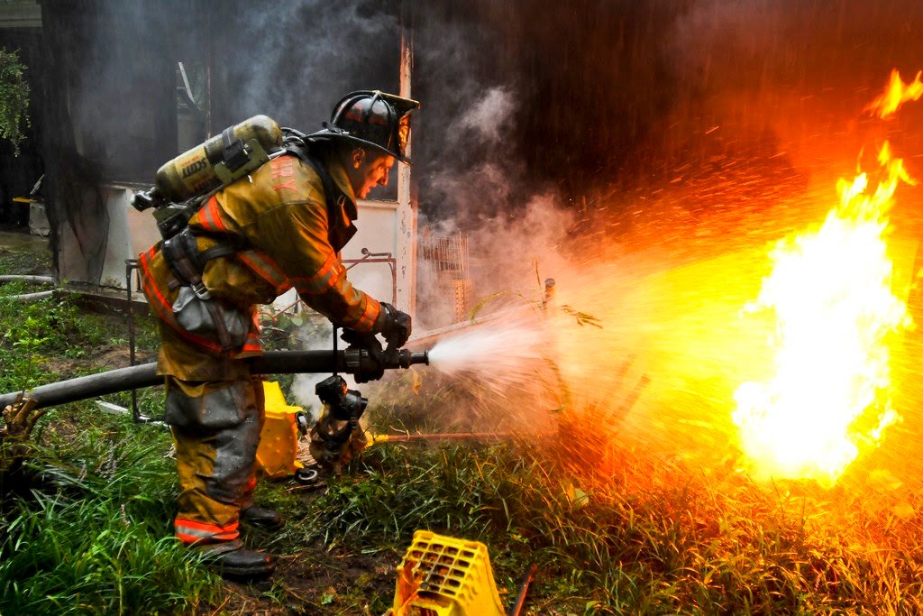 Firefighter putting out a fire outside